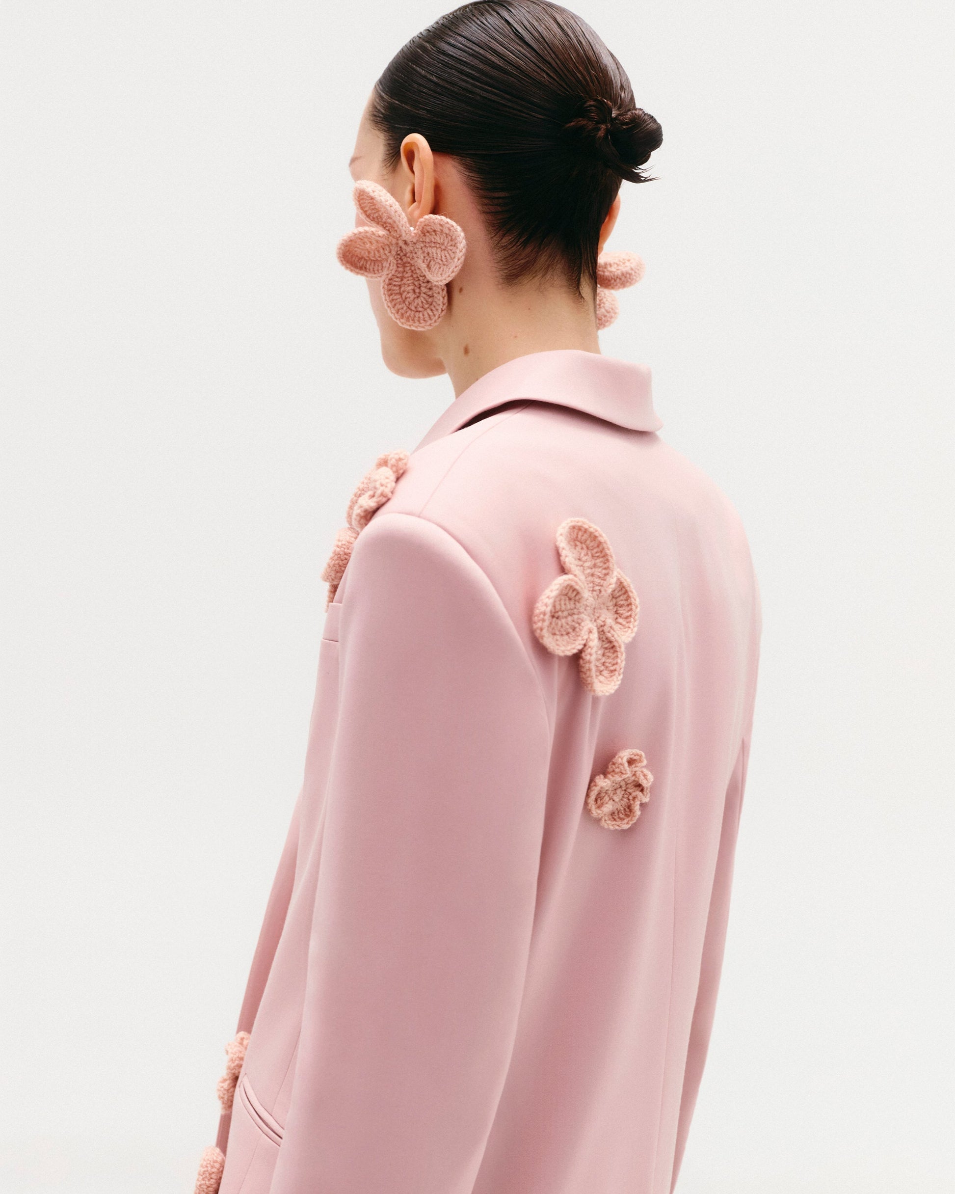 Classic hourglass jacket with crochet floral appliqués (handcrafted decor).