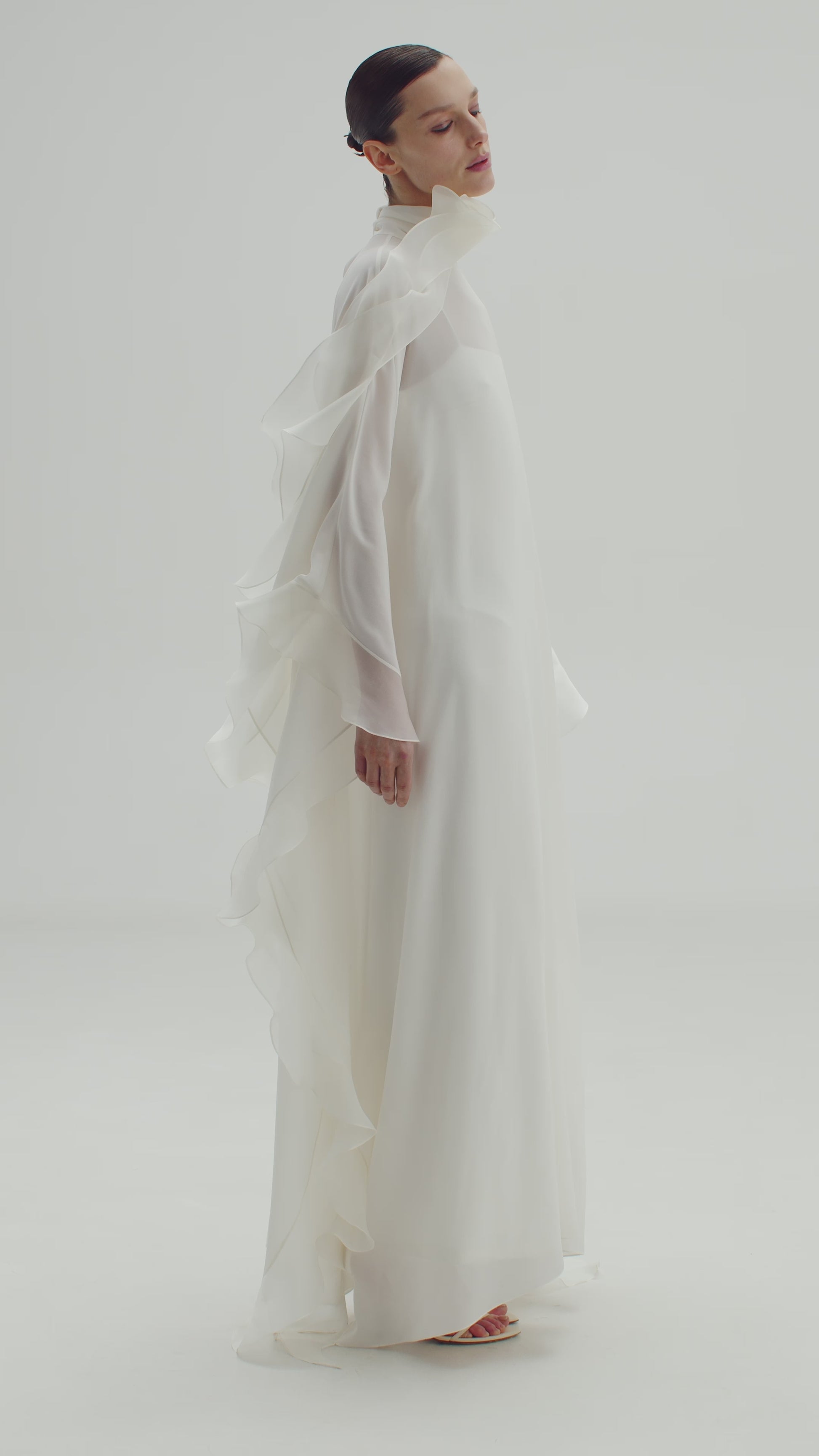 High-Neck Cape Dress Adorned With Cascading Decorative Accents