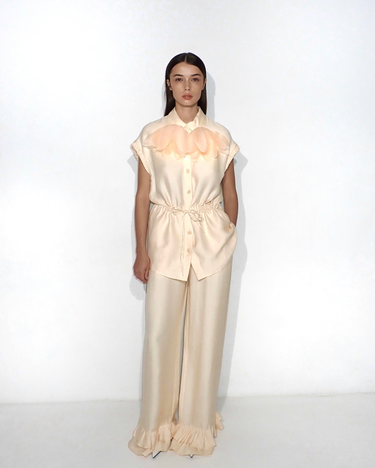 Wide-leg ruffle-hem trousers in light apricot