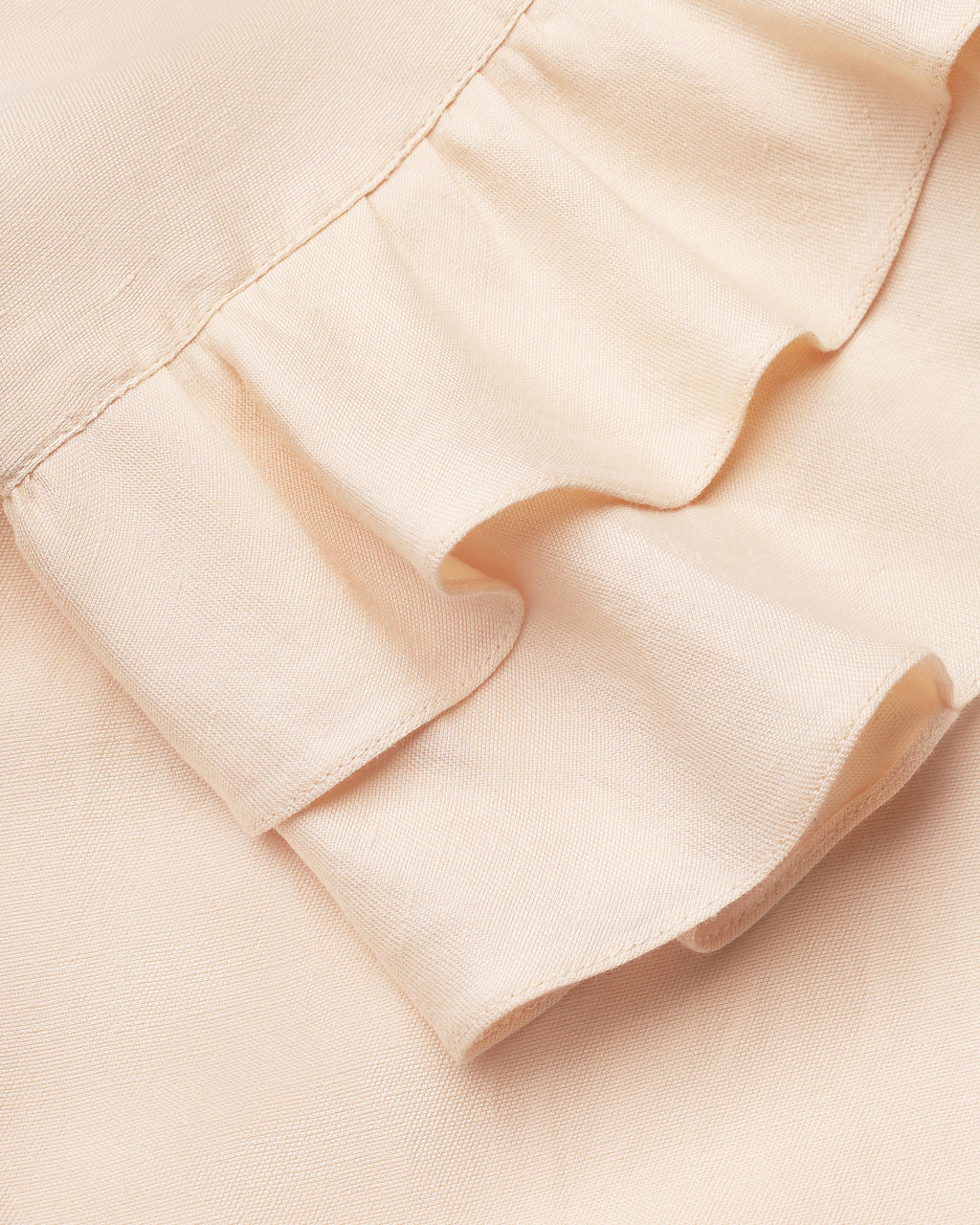 Wide-leg ruffle-hem trousers in light apricot