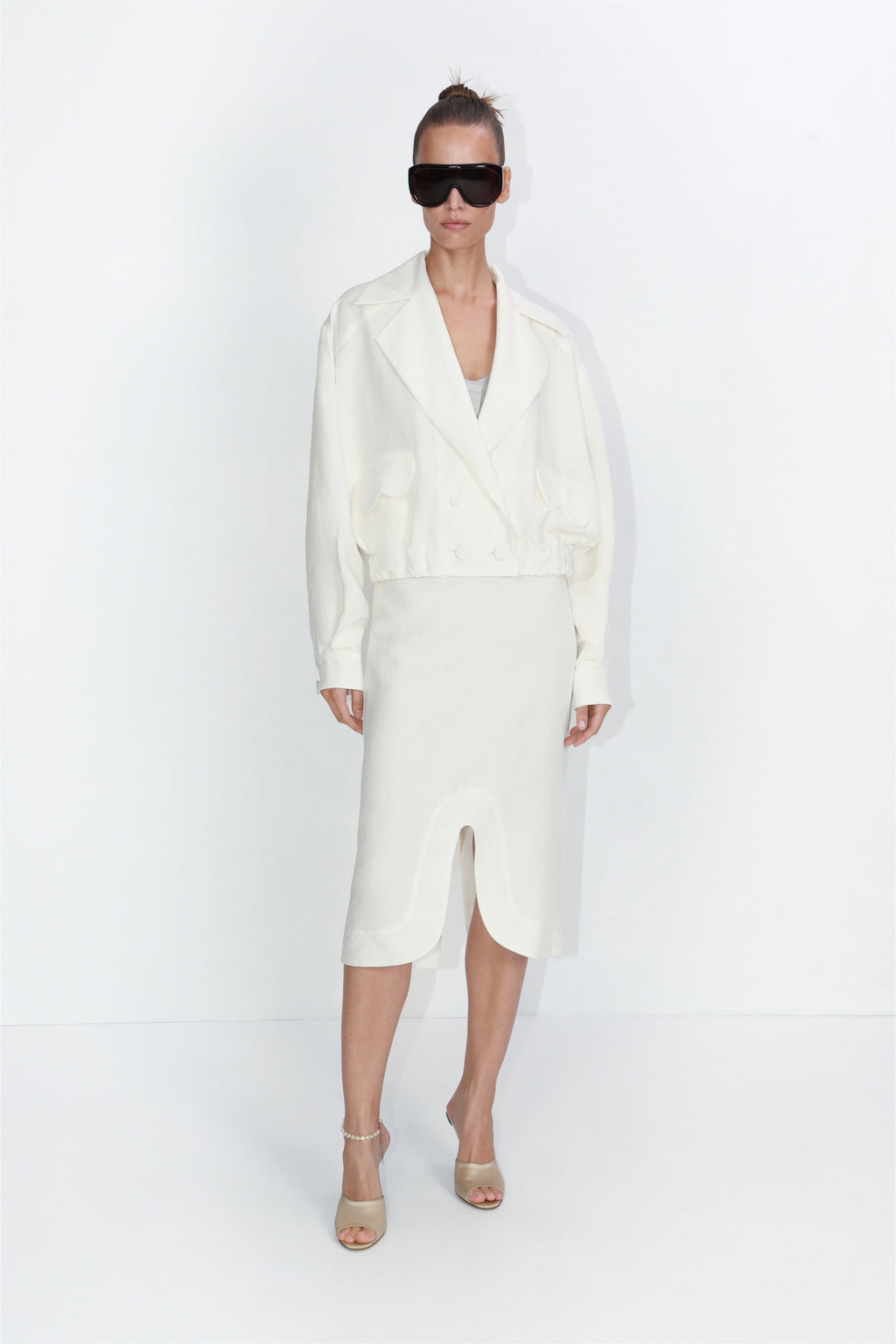 Cropped linen blazer with architectural pockets in ivory