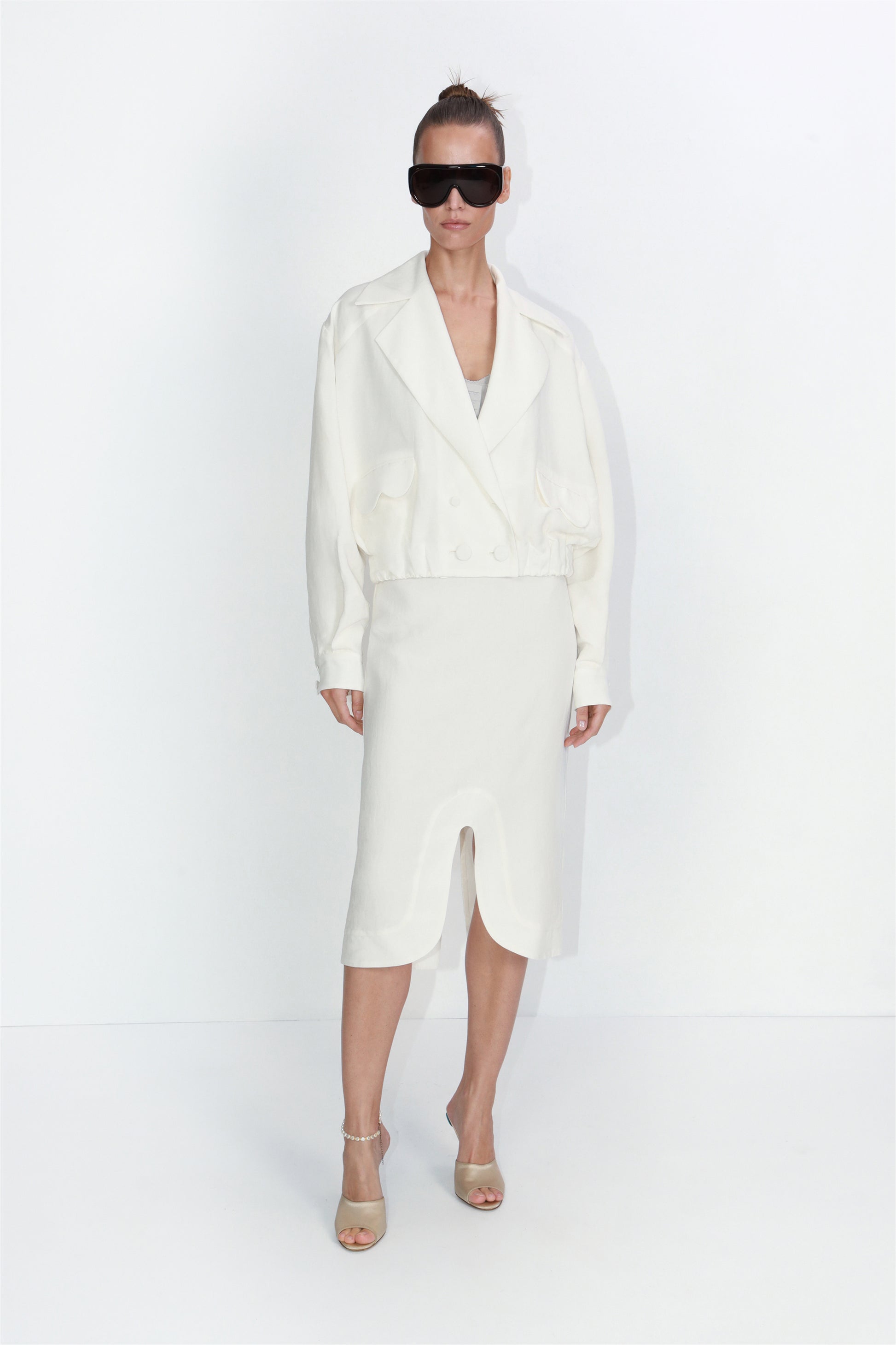 Cropped linen blazer with architectural pockets in ivory