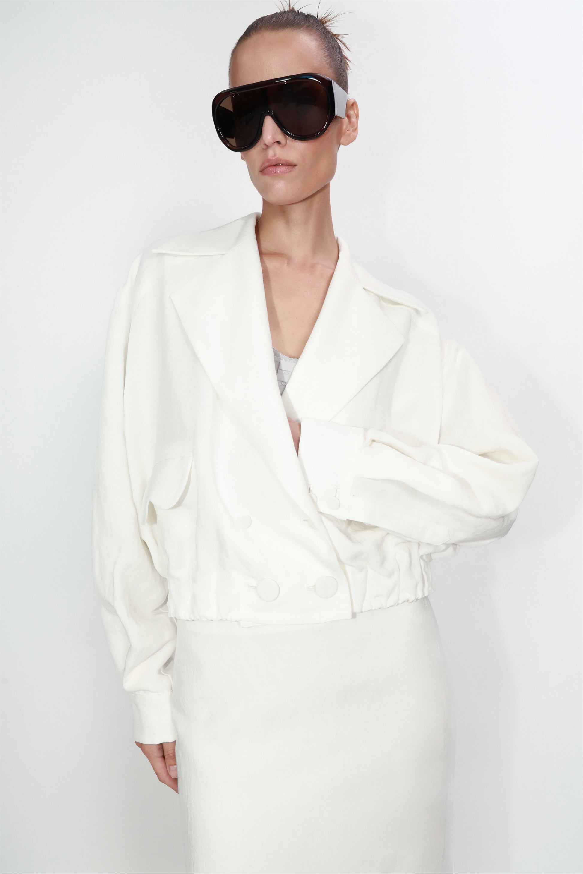 Cropped linen blazer with architectural pockets in ivory