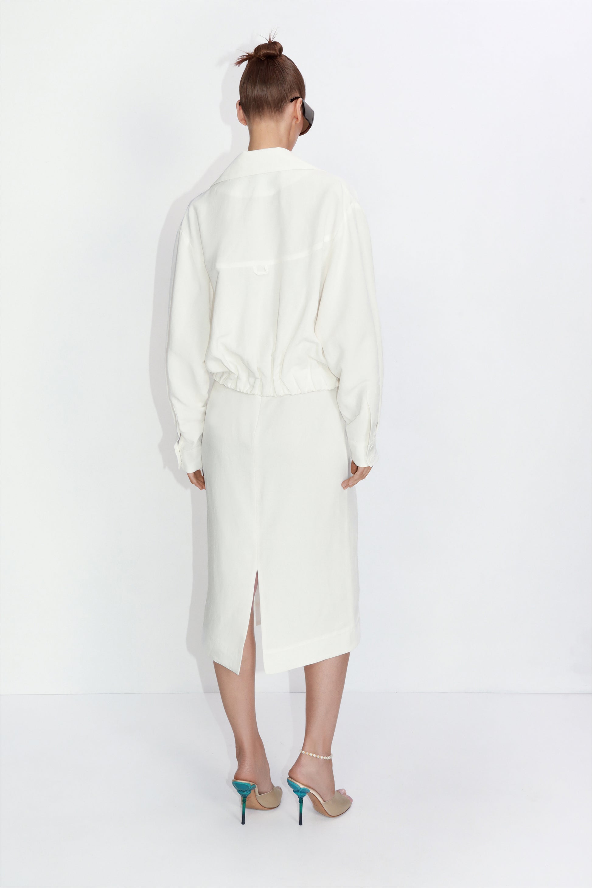 Cropped linen blazer with architectural pockets in ivory