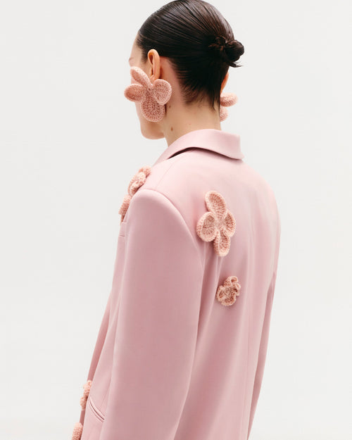 Classic hourglass jacket with crochet floral appliqués (handcrafted decor).