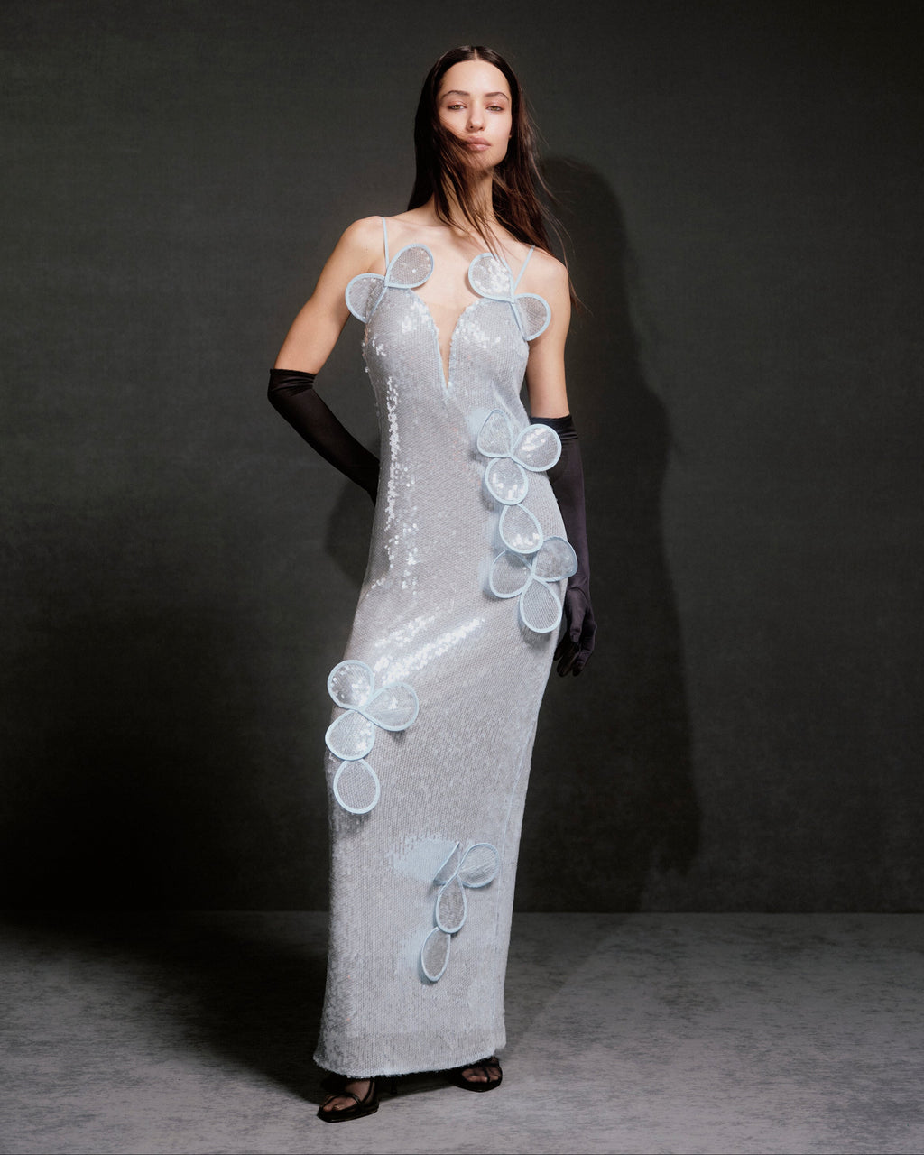 Sequin maxi bustier dress with floral appliqués and layered petals.