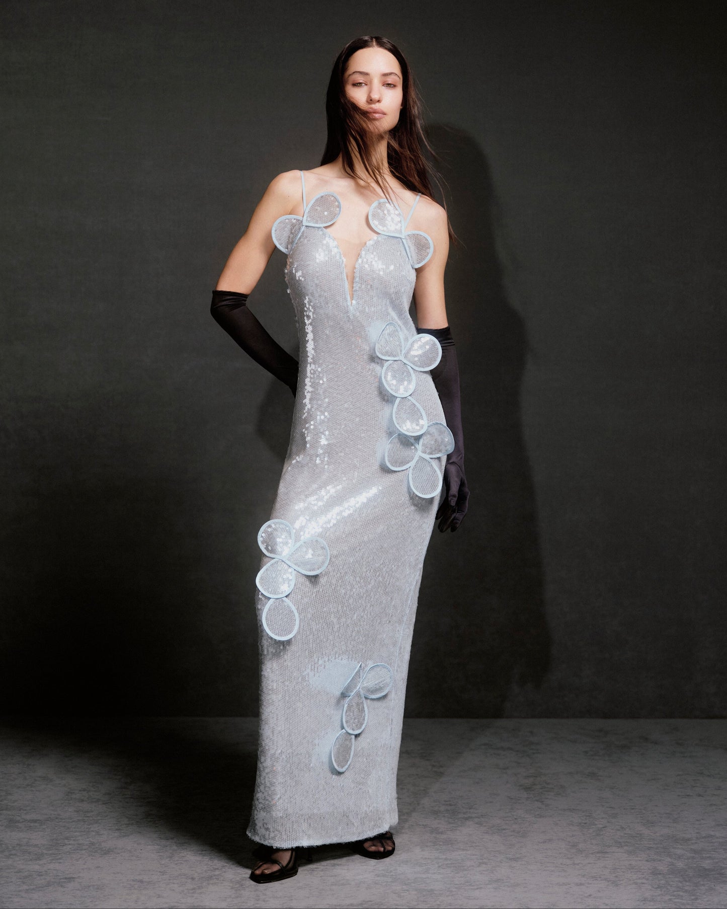 Sequin maxi bustier dress with floral appliqués and layered petals.