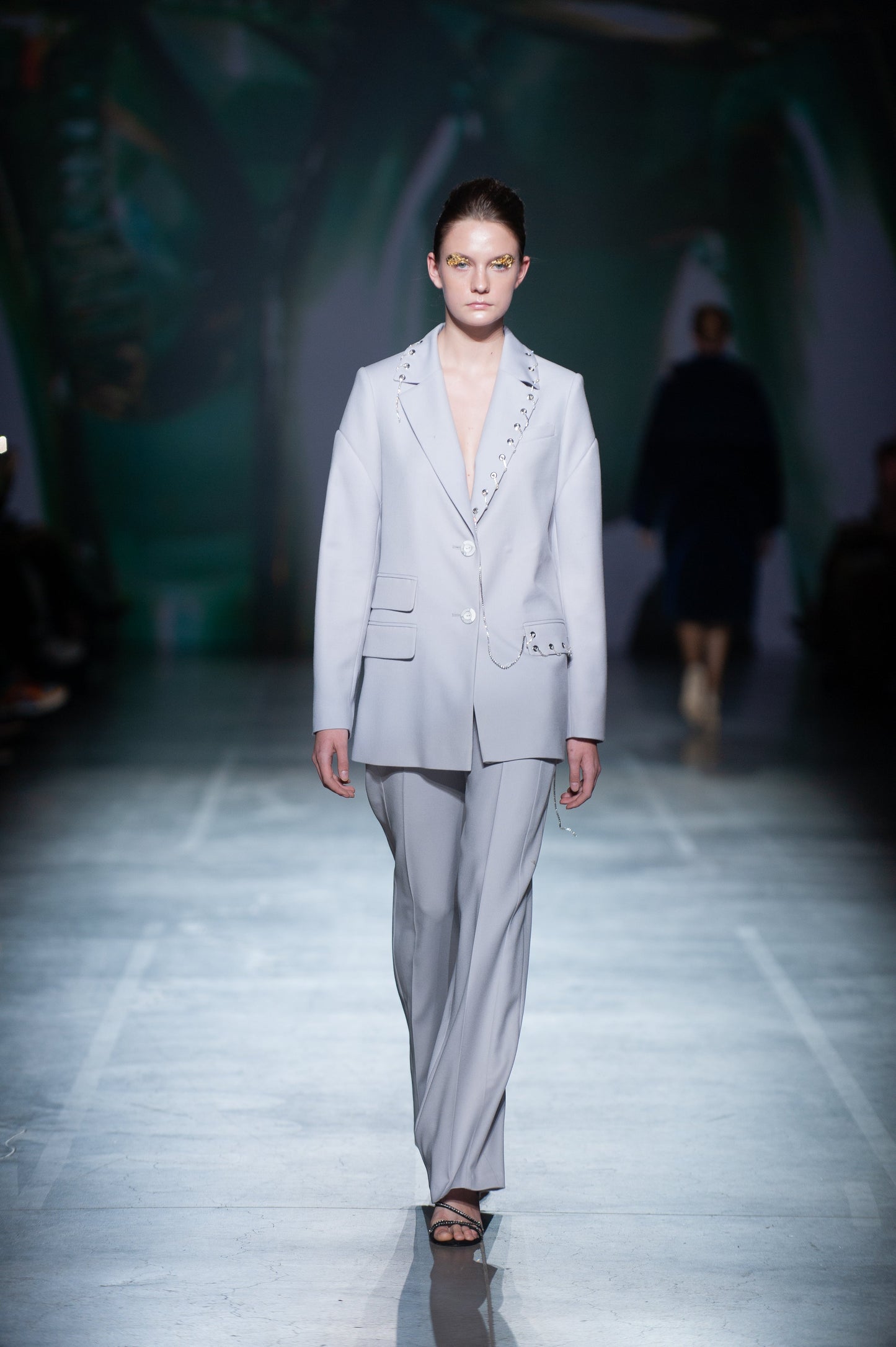 Straight jacket with textured details sleeves and decorative elements.