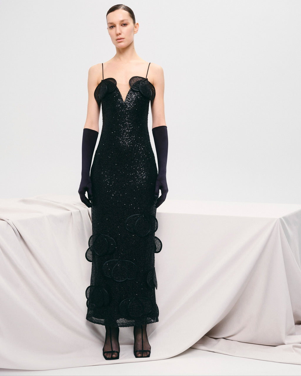 Sequin maxi bustier dress with floral appliqués and layered petals.