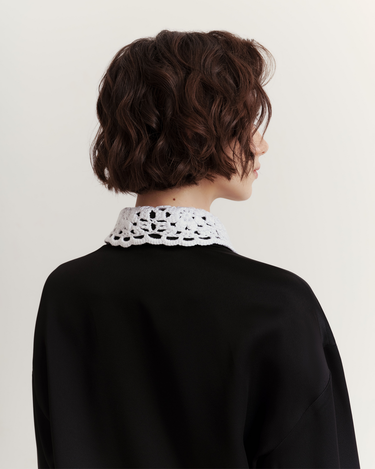 Shirt with a detachable handcrafted crochet collar.