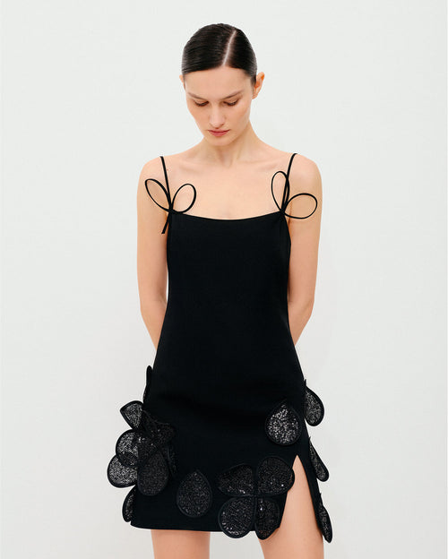 Black mini dress with floral decorative elements and straps